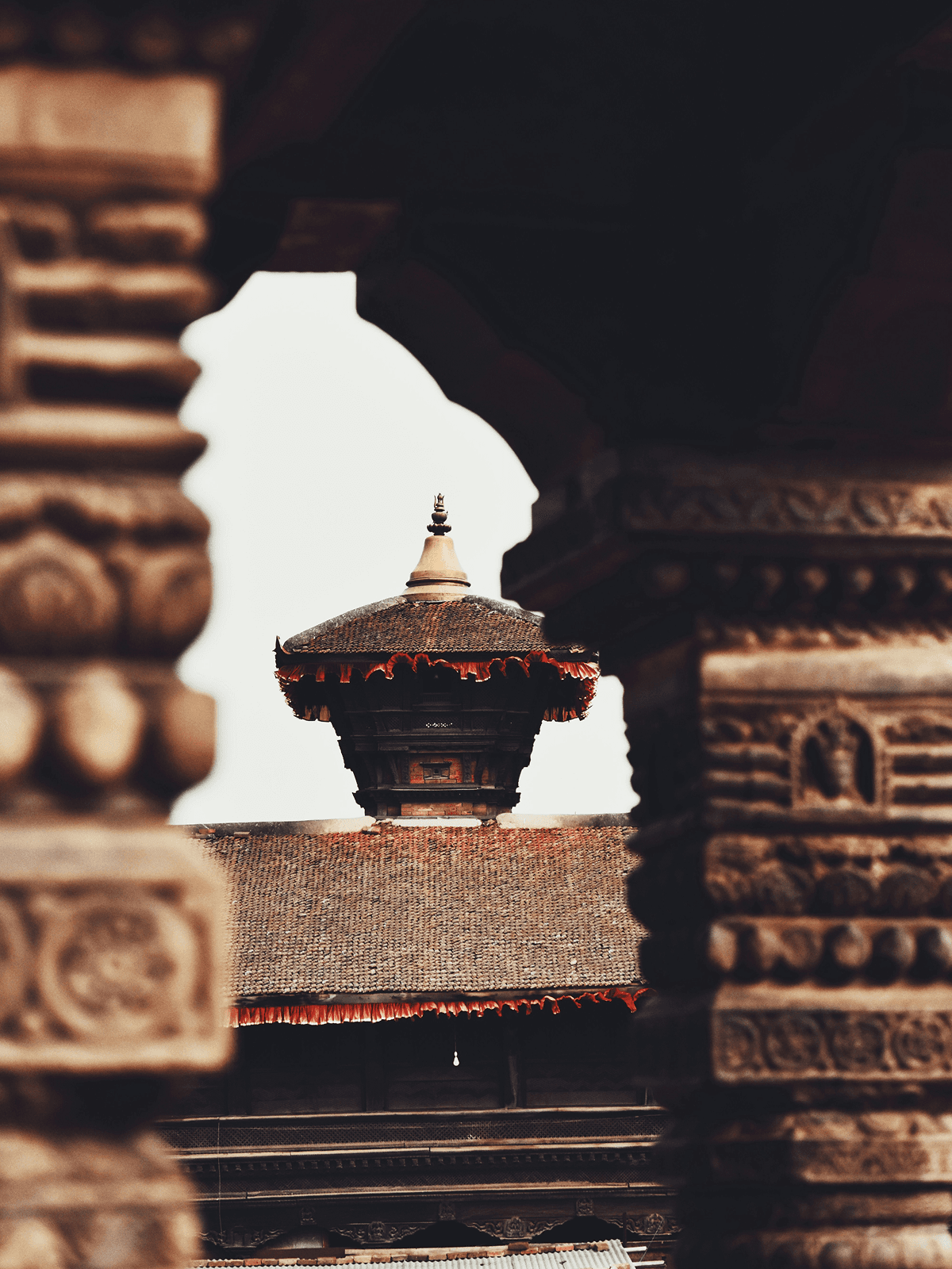 Traditional stone pillars and temple roof