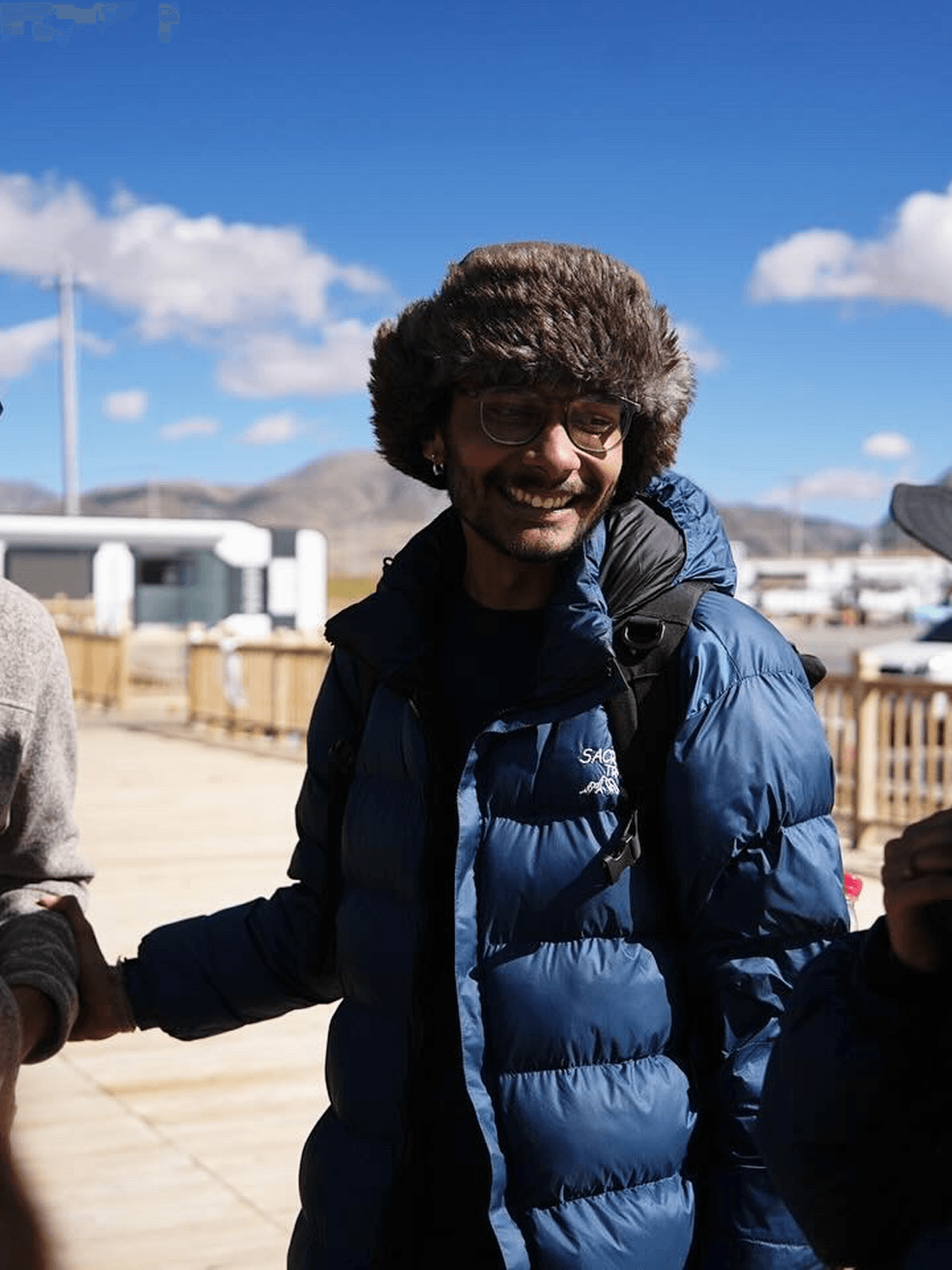 Trekker in winter gear smiling