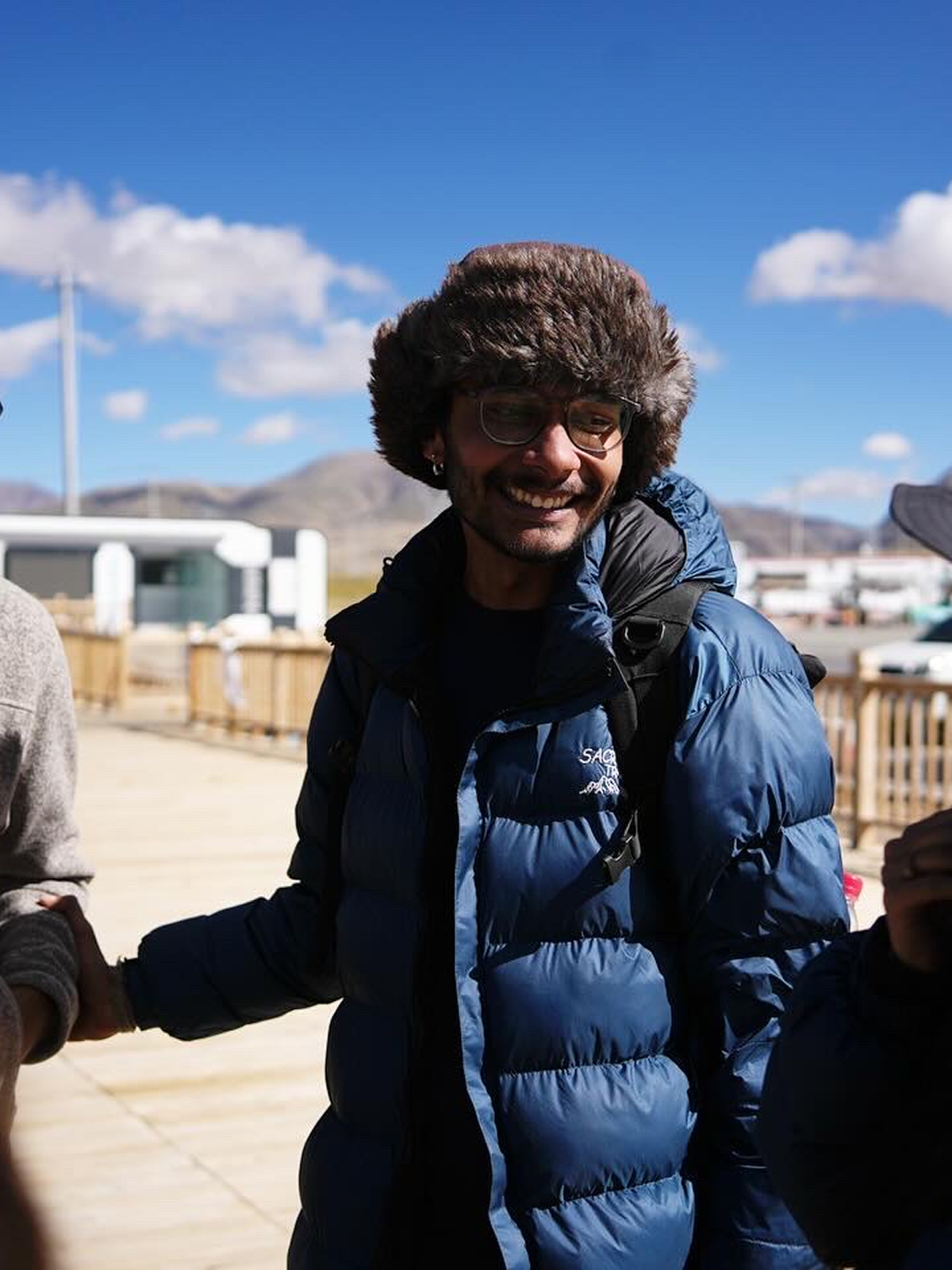 Trekker in winter gear smiling
