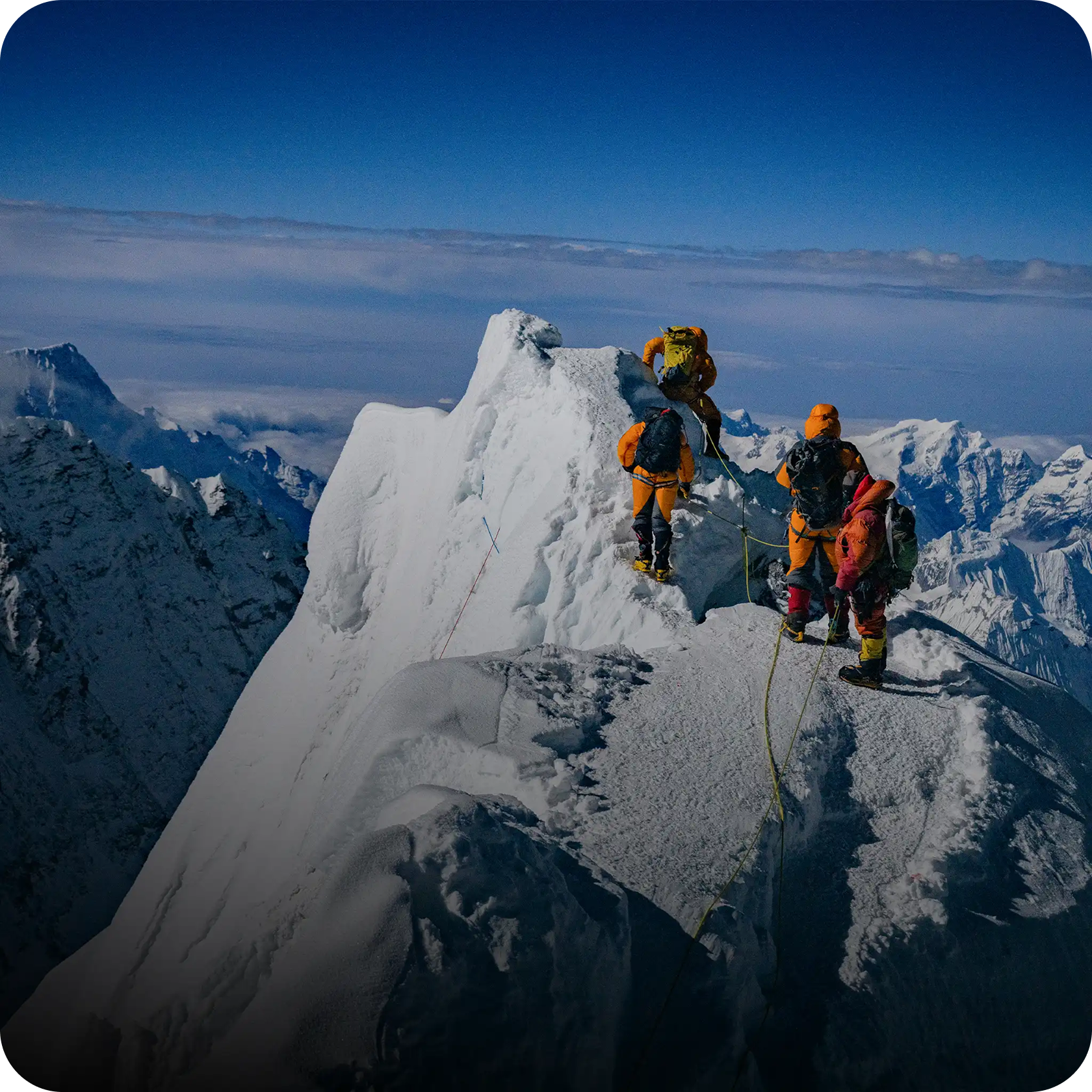 Trekkers on a snowy ridge toward Everest region